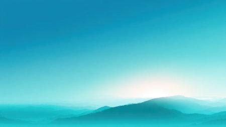 A beautiful mountain landscape is captured during sunrise. Soft blue tones and mist create a tranquil setting, highlighting the peaks and valleys in a peaceful morning light.の素材