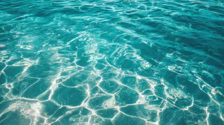 Sunlight reflects off the clear turquoise water creating a shimmering surface on a bright summer day.の素材