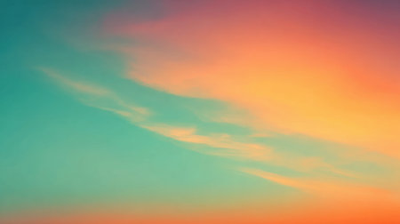 Soft pastel hues of orange pink and blue blend in the sky at sunset over a calm landscape creating a tranquil and serene atmosphere in the evening light.の素材