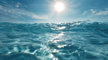 Sunlight sparkles on clear blue ocean water creating a serene scene. Gentle waves ripple under a bright sky making it a perfect day for relaxation by the coast.の素材