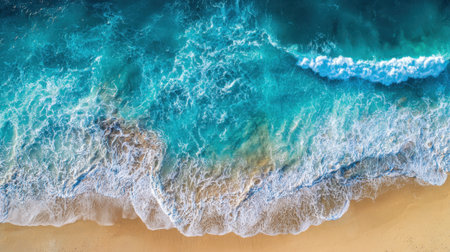 Bright sunlight illuminates a beautiful coastline where soft waves crash onto golden sand. The calm blue waters create a picturesque scene of nature's tranquility.の素材