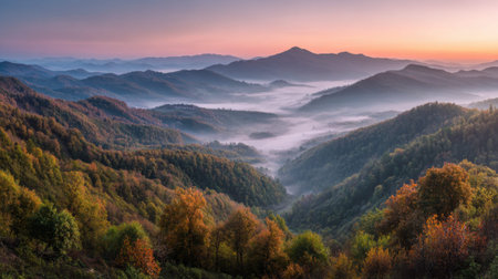 Serene mountain landscape at sunrise with misty valleys and vibrant autumn foliage.の素材