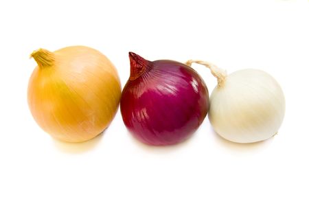 Three coloured onions  in varied colors on white background.の写真素材