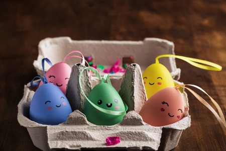 Colorful Easter eggs in box on wooden background. Easter holiday concept. Copyspace for text. Close - up.の写真素材