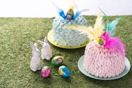 Mona de pascua, a pink and blue cakes eaten in Spain on Easter Monday, decorated with a chocolate...