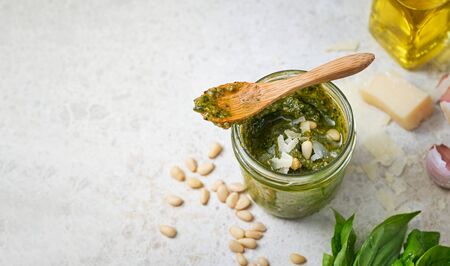 Pesto Sauce with Ingredients: Fresh Basil, Pine Nuts, Garlic and Cheese, banner, copy space for your text. Top view. Selective focus.の写真素材