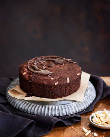 Healthy chocolate cake with almonds non sugar on a plate on the old wooden background. Selective focus. Keto diet.の写真素材