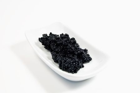 Black caviar on white little dishの写真素材