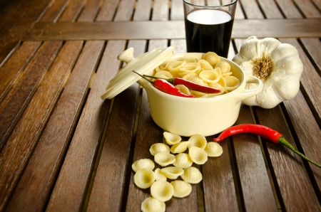 Uncooked Orecchiette, italian pasta, in a bowl with ingredientsの写真素材