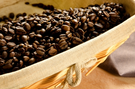 Roasted coffee beans in a basket with rustic canvasの写真素材