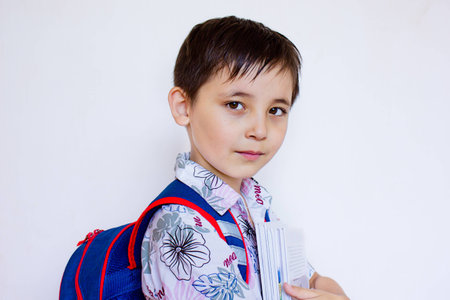 a boy with a backpack and books