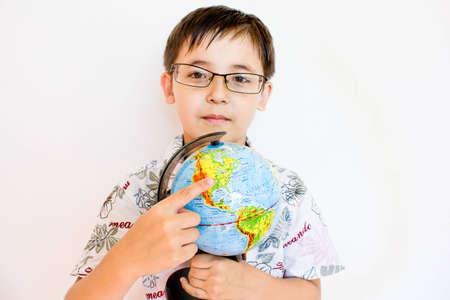 a boy holding a globeの写真素材