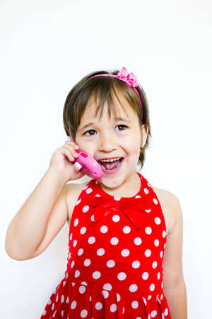 little girl talking on the phoneの写真素材