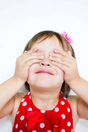 the little girl covered her eyes with her handsの写真素材