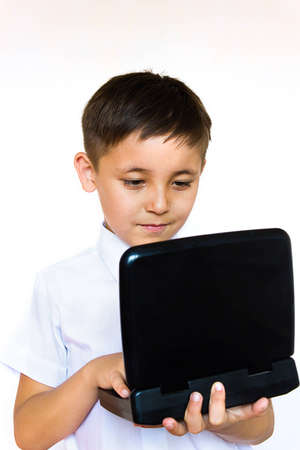 a little boy enthusiastically looking at laptopの写真素材