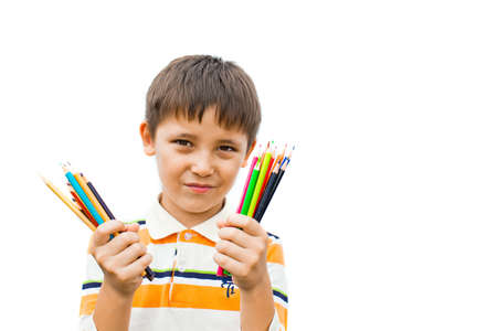 boy with colored pencils in their handsの写真素材