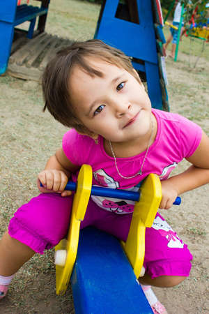 happy, little girl playing on the playground,in kindergartenの写真素材
