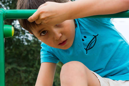 cute, nice boy playing on the playgroundの写真素材