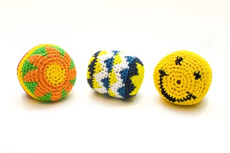 Three small colourful ball made of knitted wool. Isolated on a white background の写真素材