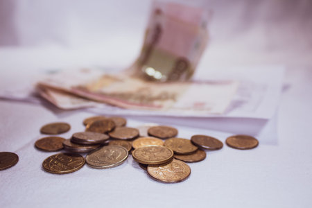 Coins and banknotes, Russian rubles. Selective focus. Blurred background with paper money.