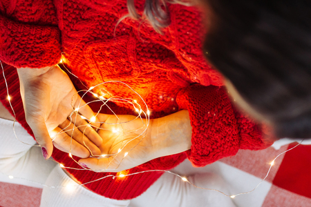 pregnant woman hold Christmas lightの写真素材