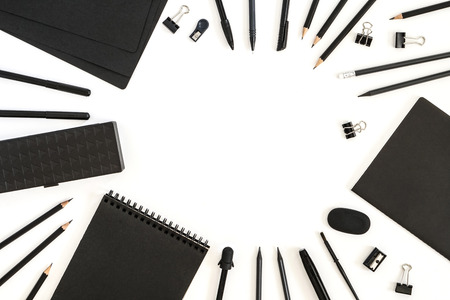 Office supplies. Back to school. Paper sheets notepad pencils pen eraser sharpener pencil case compound in the frame. Objects on white backgroundの写真素材