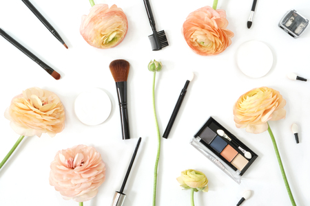 Makeup brush collection eye shadow and ranunculus flowers isolated on white backgroundの写真素材
