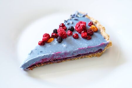 Slice of homemade cake decorated with freeze- dried berries. Photoの写真素材
