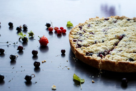 Homemade shortbread berry pie with a slice cut off. Summer photo receipts