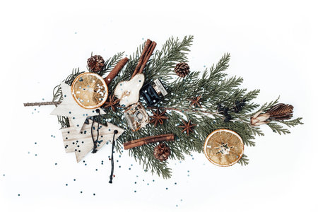Christmas composition with fir tree branch, new year wooden toys, perfume bottles, dried fruits and...