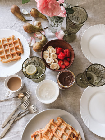 Tasty homemade breakfast set of waffles fruits and berriesの写真素材