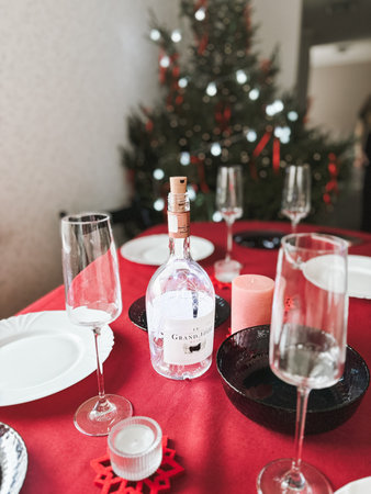 Table setting with Christmas decorations in living roomの写真素材