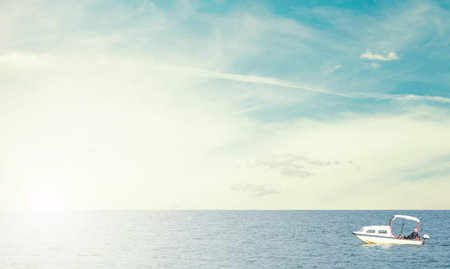 Small wooden fishing boat in blue sea