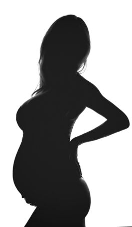Silhouette of pregnant woman. Backlit black and white profile viewの写真素材