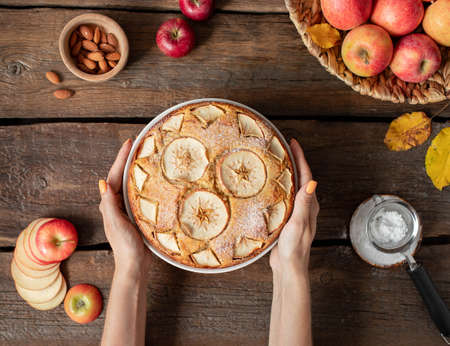 female hands hold apple pie. delicious dessertの写真素材