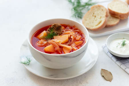 Traditional Russian Ukrainian red borscht in a white bowlの写真素材