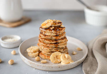 tasty oatmeal pancake with banana, nuts and date syrup. gray background, horizontal imageの写真素材