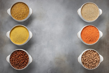 set of raw cereals (bulgur, couscous, beans, quinoa, lentils, chickpeas). food frame, place for...