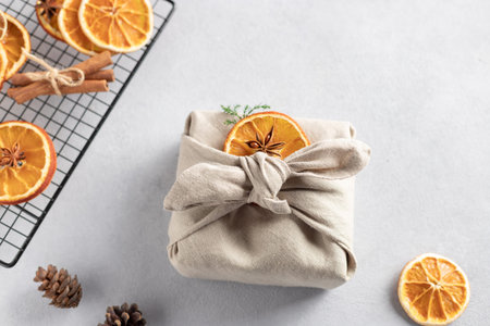 Christmas gift wrapped in linen cloth. Furoshiki Japanese Gift fabric Wrapping.