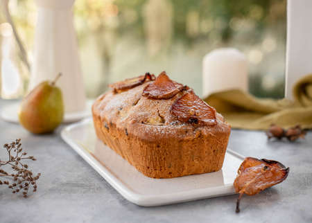 muffin cake with pears, nuts decorated with caramelized pears. Light backgroundの写真素材