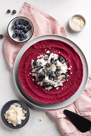 raw vegan cake with blueberries and coconut chipsの写真素材