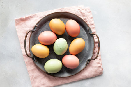 Easter eggs in vintage tray and one cracked egg in the middle