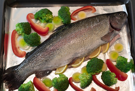 whole raw rainbow trout with broccoli, leek, red pepper and spices