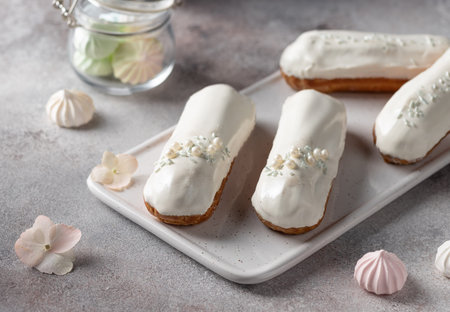 white glaze eclairs on white serving board