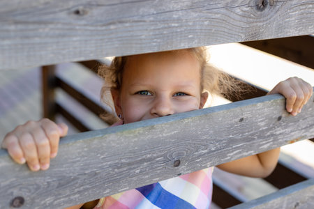 portrait of little girl child near wooden railingの写真素材