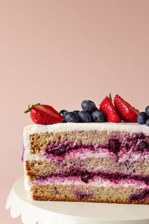 half blueberry cake decorated fresh berriesの写真素材