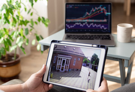 Father working at home and monitoring home security camera