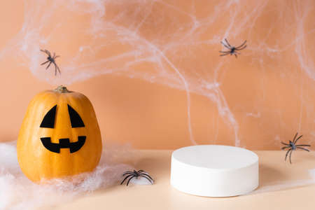 White podium with fun scary face pumpkinの写真素材