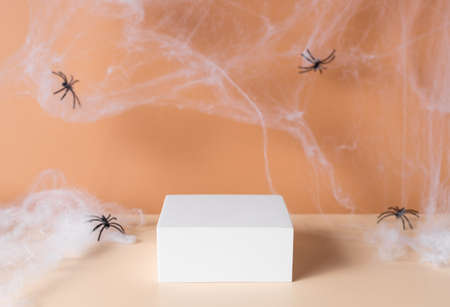 Spooky Halloween background with white podium and spider webの写真素材