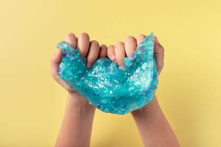 child playing with blue slime. Hands gumの写真素材